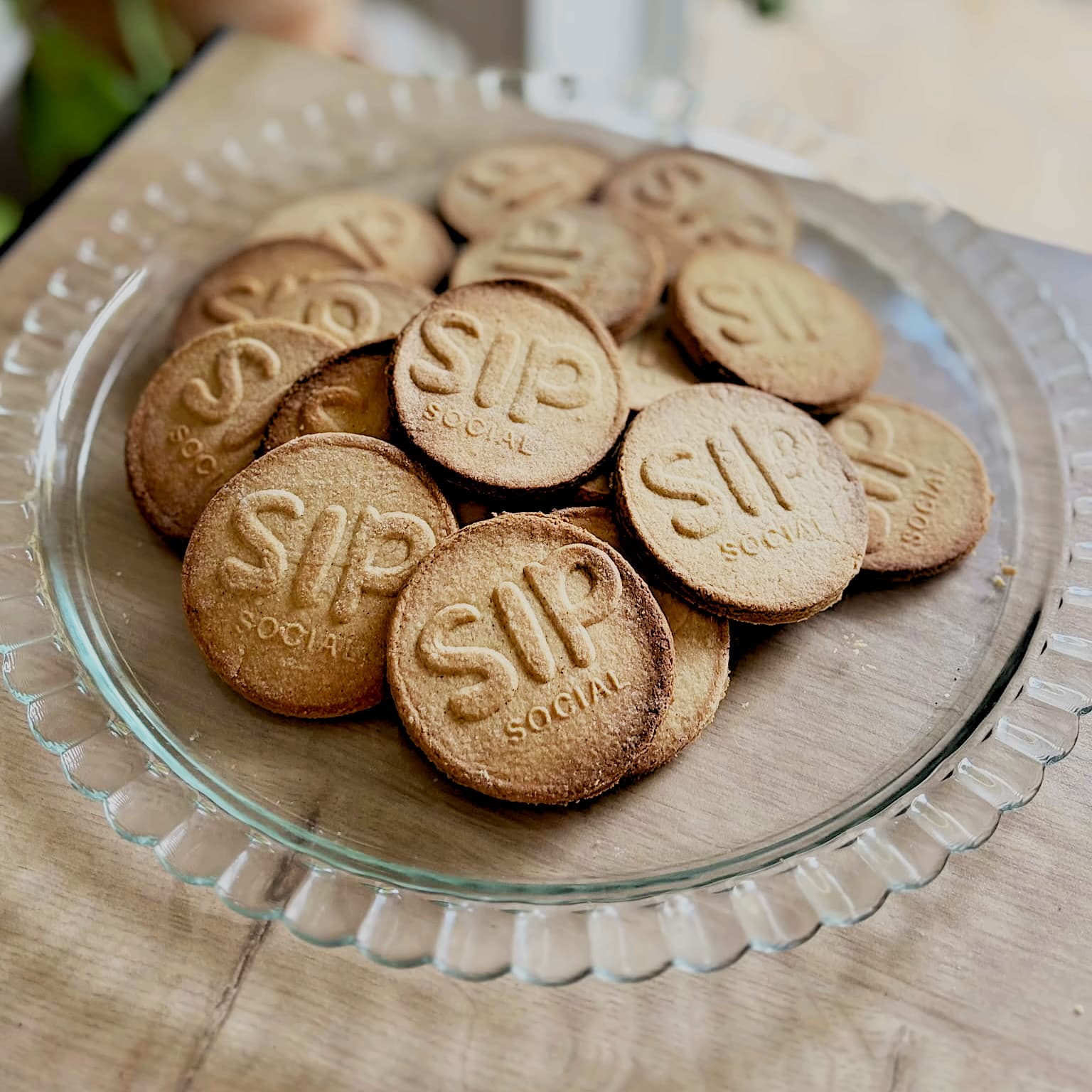 Shortbread biscuits stamped with the Sip Social logo