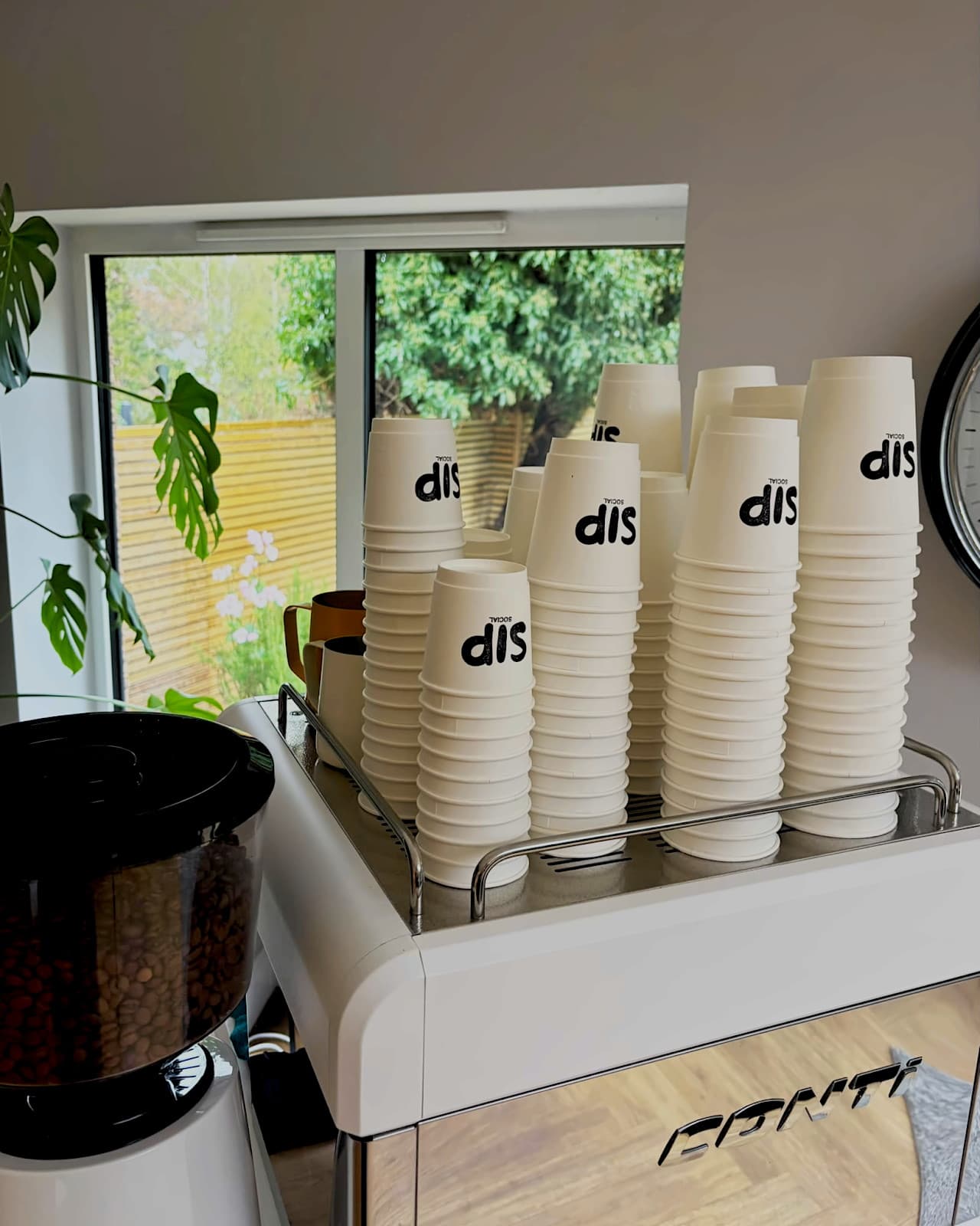 Stacks of branded Sip Social cups ready for guests