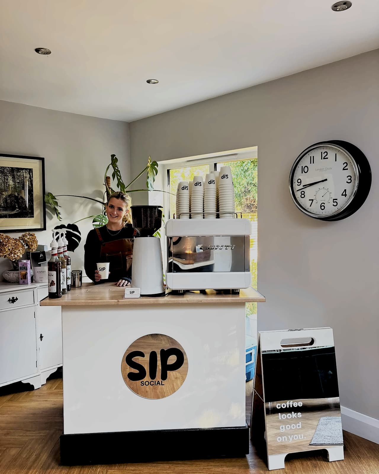 Barista serving coffee from behind the Sip Social cart