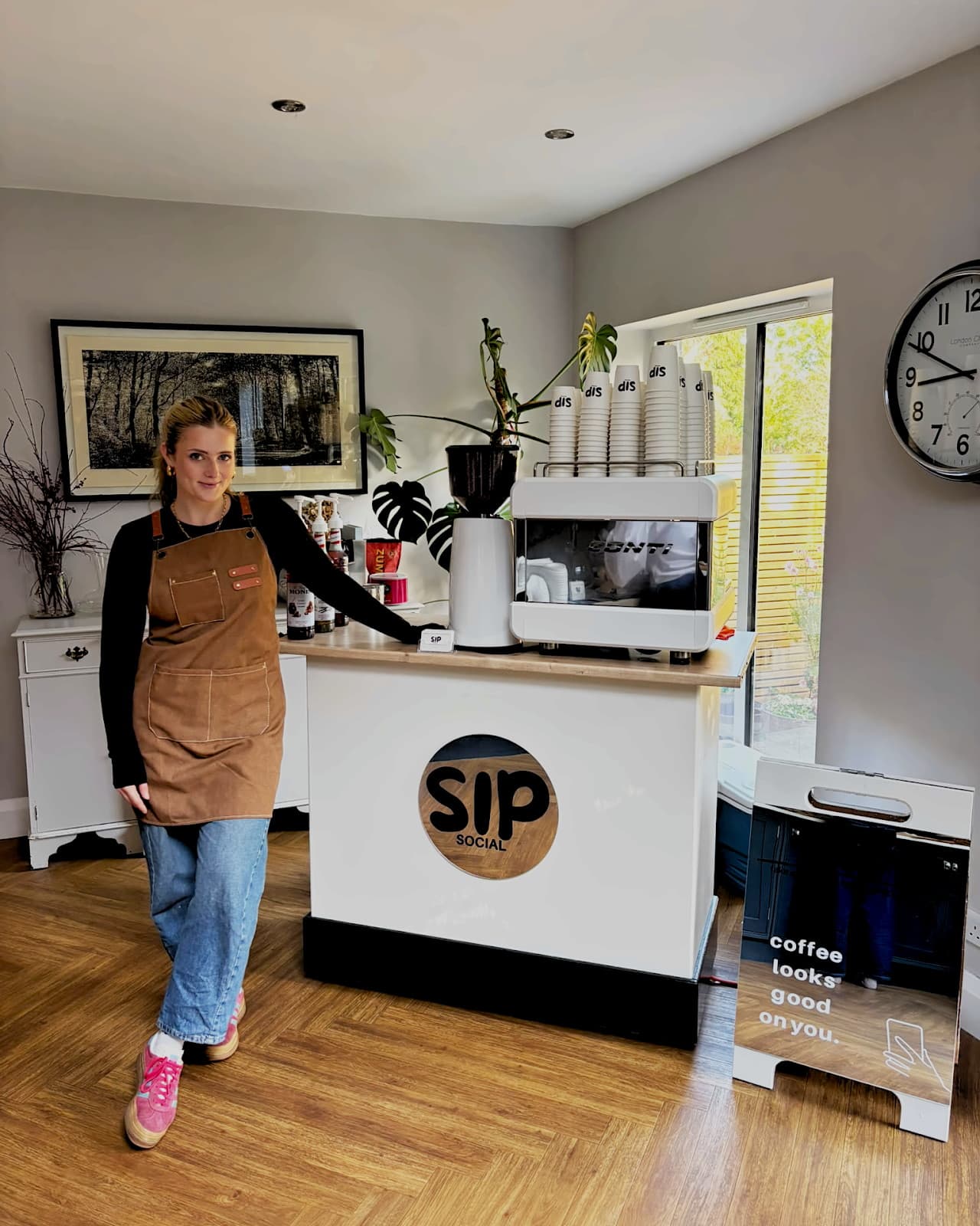 Zoe Stone standing beside the Sip Social coffee cart